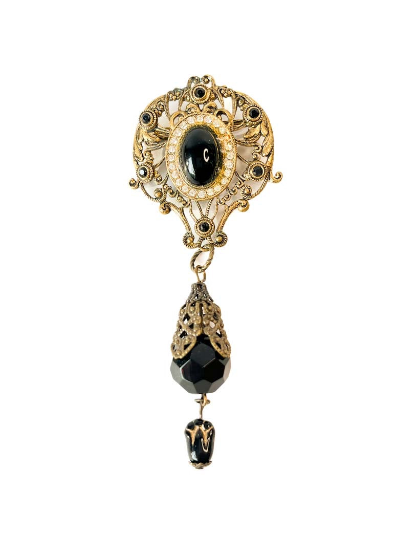 Prendedor vintage estilo victoriano con filigranas, cristal negro y colgante articulado