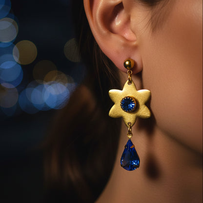 aros colgantes dorados de estrella y cristal azul