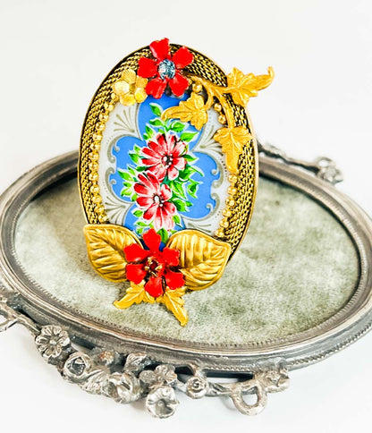 camafeo flores azules y rojas porcelana metal